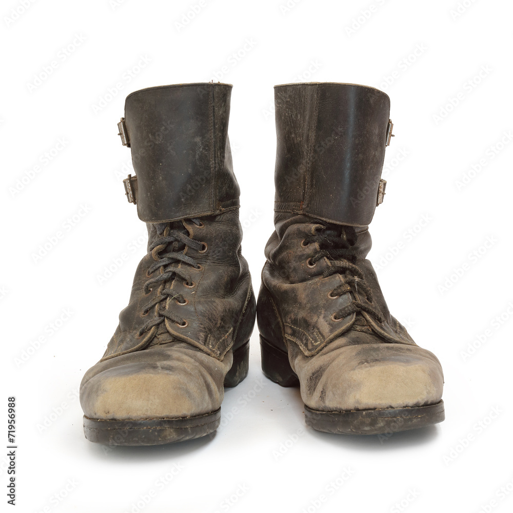 Old army combat boots on white background.