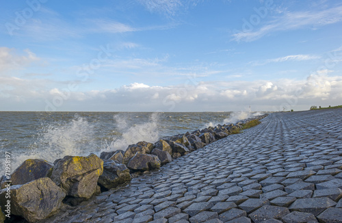 Wallpaper Mural Basalt stones along a dike in a stormy sea Torontodigital.ca