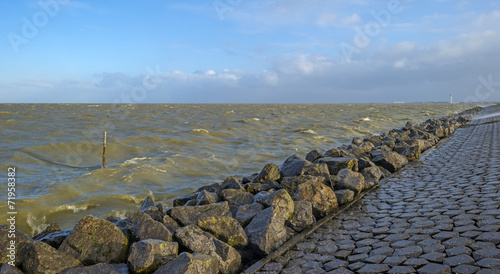 Basalt stones along a dike in a stormy sea © Naj