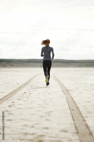 Young woman running at the beach