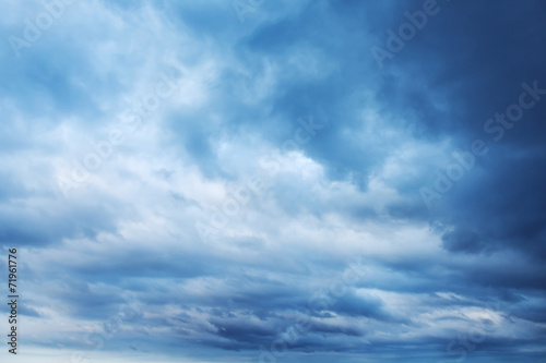 Dark blue sky with clouds, abstract background