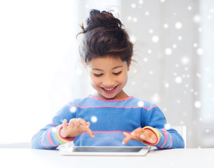 smiling girl with tablet pc at home