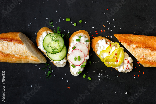 Canapes with cottage cheese  on a black background photo