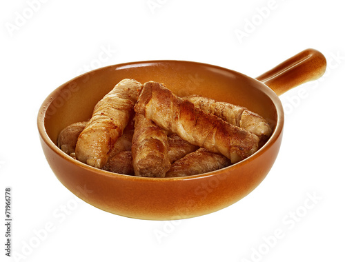 sausages wrapped in bacon in a frying pan photo