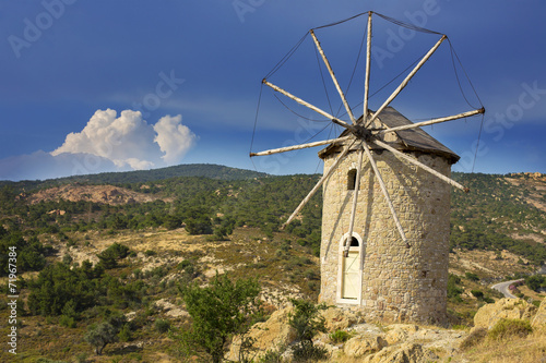 Historical old windmill with a dramatic sky background