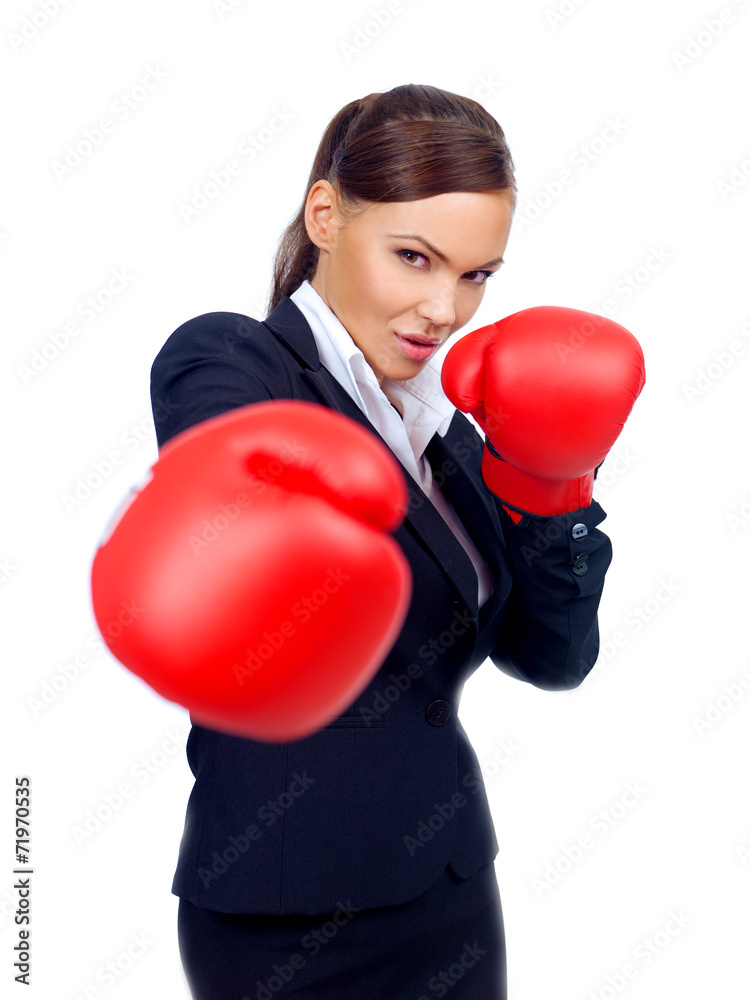 Determined businesswoman throwing a punch Determined businesswoman throwing a punch