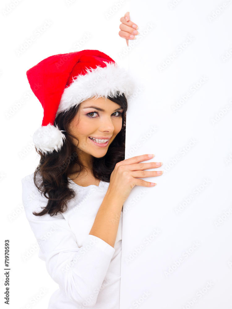 Cute woman wearing Santa hat with a blank sign Cute woman wearing Santa hat with a blank sign