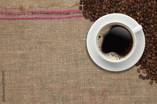 Coffee beans and Coffee cup on a jute background