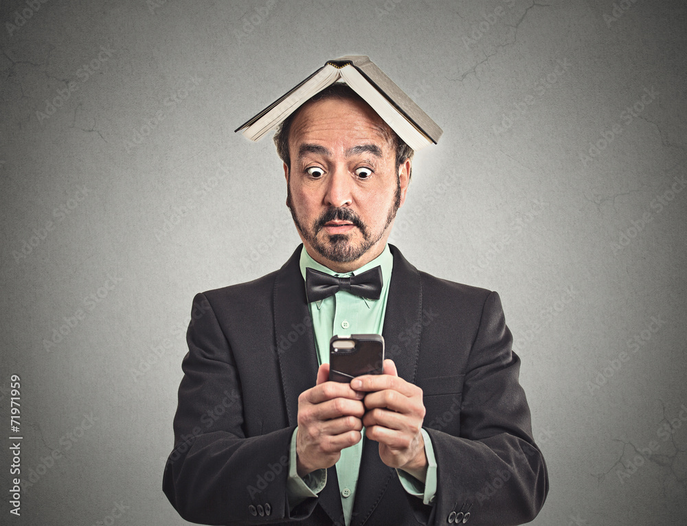 surprised man reading news on smart phone on grey background surprised man reading news on smart phone on grey background