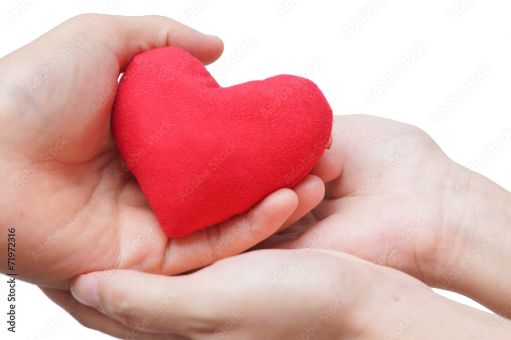 male hand giving a red heart to a female hand male hand giving a red heart to a female hand