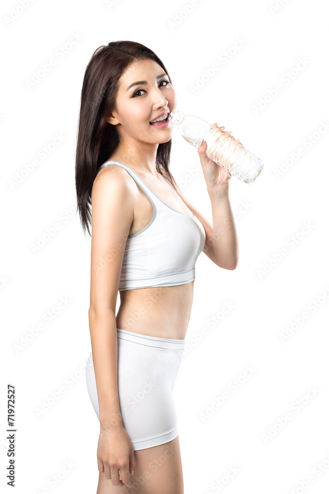 Excited young asian woman showing a bottle of water after doing Excited young asian woman showing a bottle of water after doing