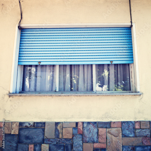 Vintage facade and window with metal blinds