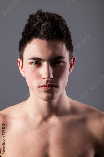 Handsome face of a young man on grey © Sergii Figurnyi