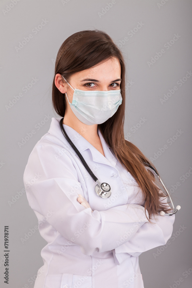 Doctor / nurse smiling behind surgeon mask. Closeup portrait of Doctor / nurse smiling behind surgeon mask. Closeup portrait of