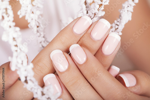 Beautiful woman's nails with french manicure. photo