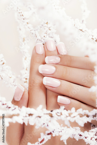 Beautiful woman s nails with french manicure.