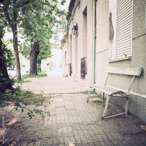 Vintage bench in a tranquil sidewalk © Andreka Photography