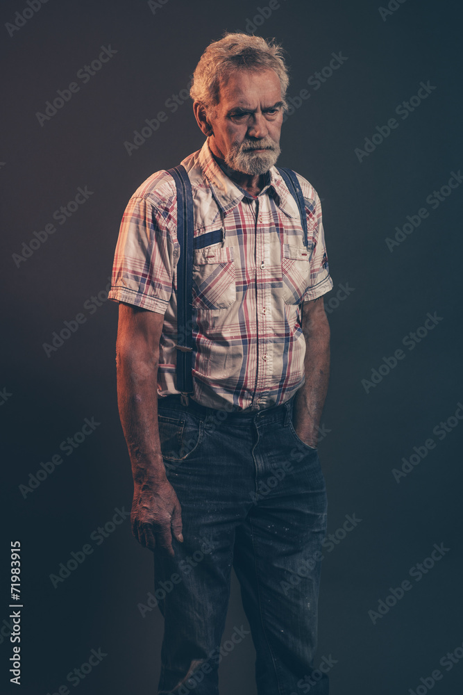 Characteristic senior man with gray hair and beard wearing check