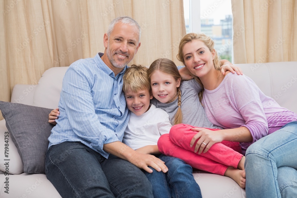 Happy parents with their children on sofa Happy parents with their children on sofa