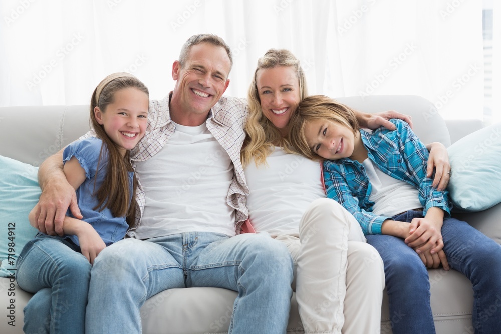 Parents and children sitting together on couch