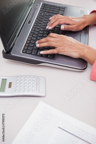 Casual businesswoman typing on laptop