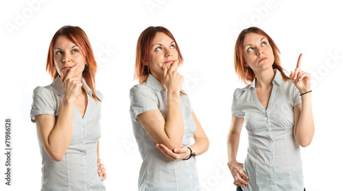 Pretty young girl thinking over white background