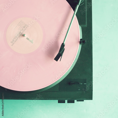 Vintage turntable with pink vinyl record