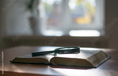Book and glass loupe