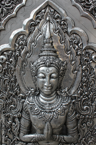 Deva silver carving art on temple wall.