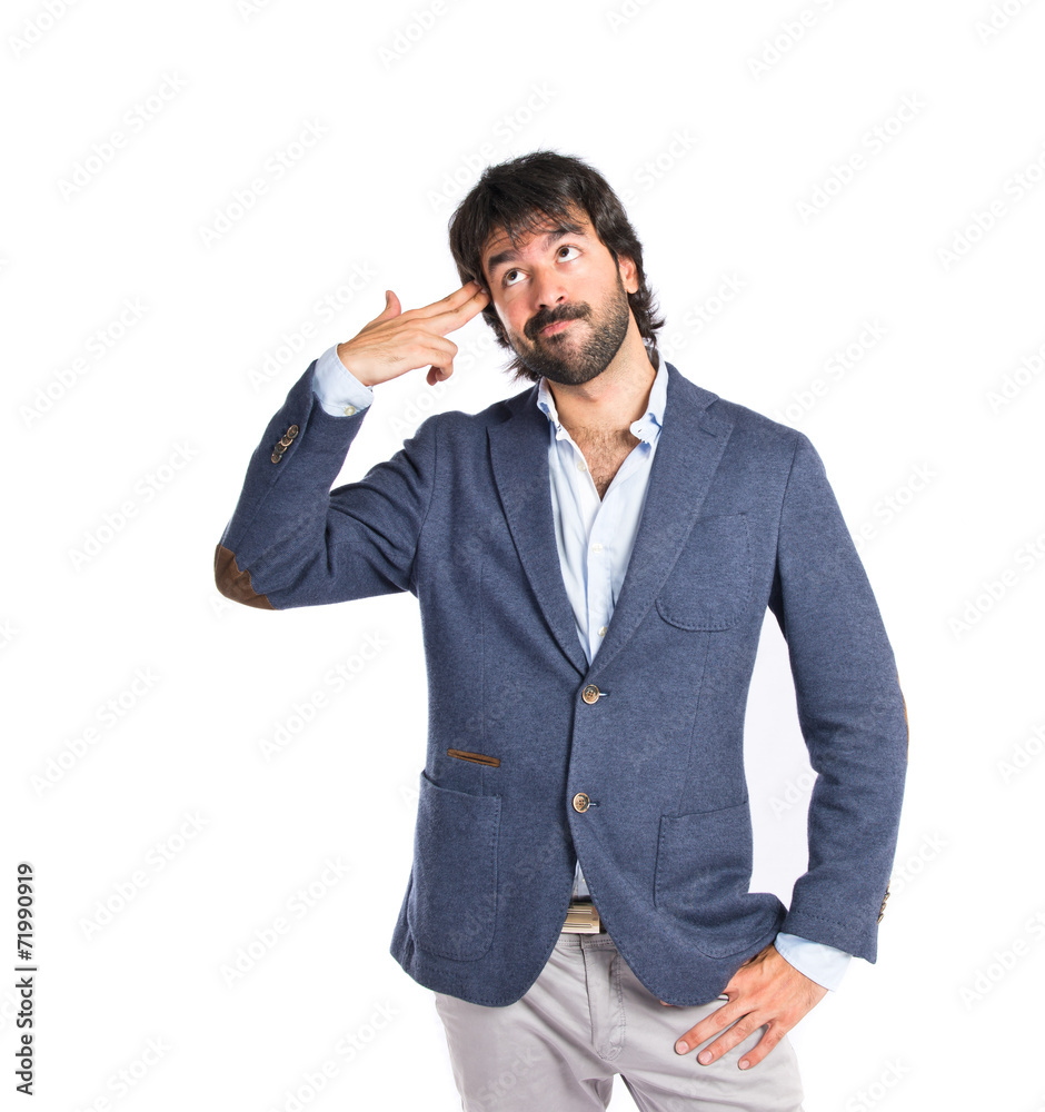 Handsome man making suicide gesture over white background Handsome man making suicide gesture over white background