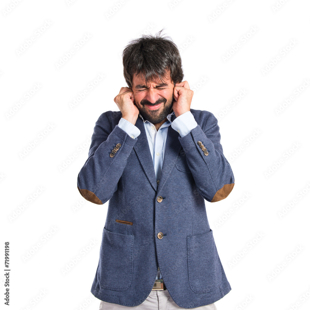 Man covering his ears over white background Man covering his ears over white background