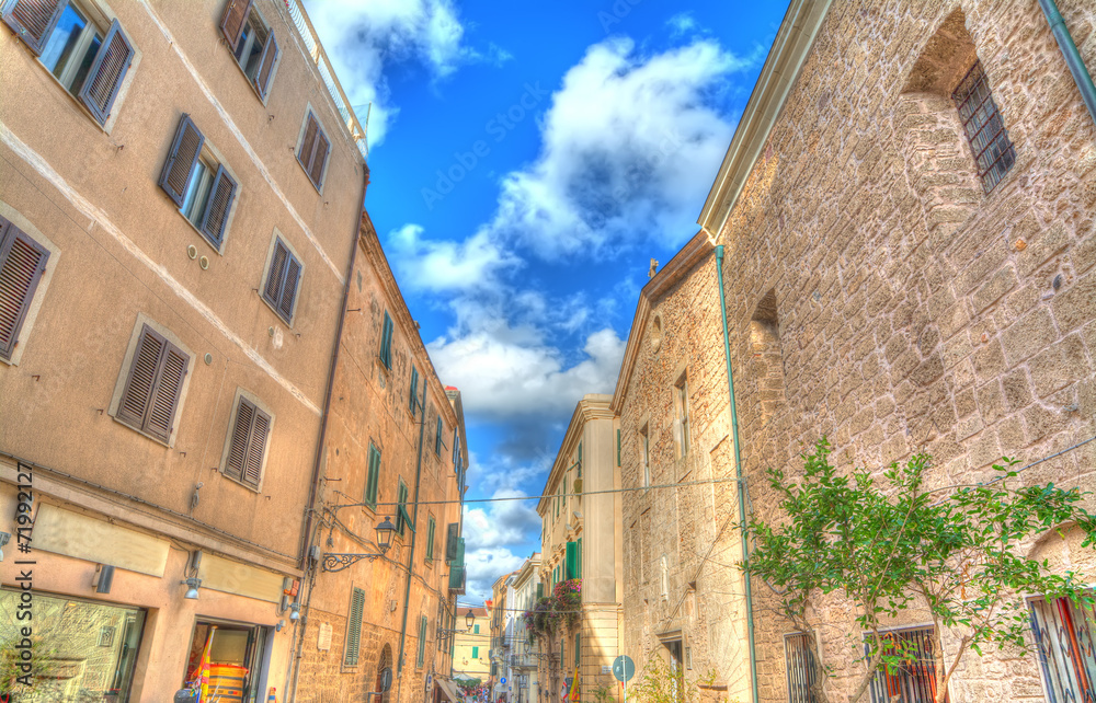 narrow street in Alghero old town on a clear day