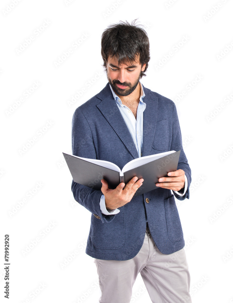 Businessman reading a book over white background Businessman reading a book over white background