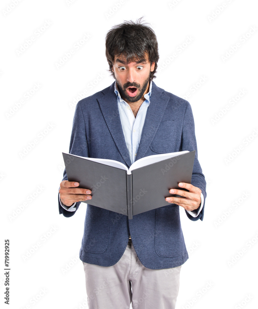 Surprised man reading a book over white background Surprised man reading a book over white background