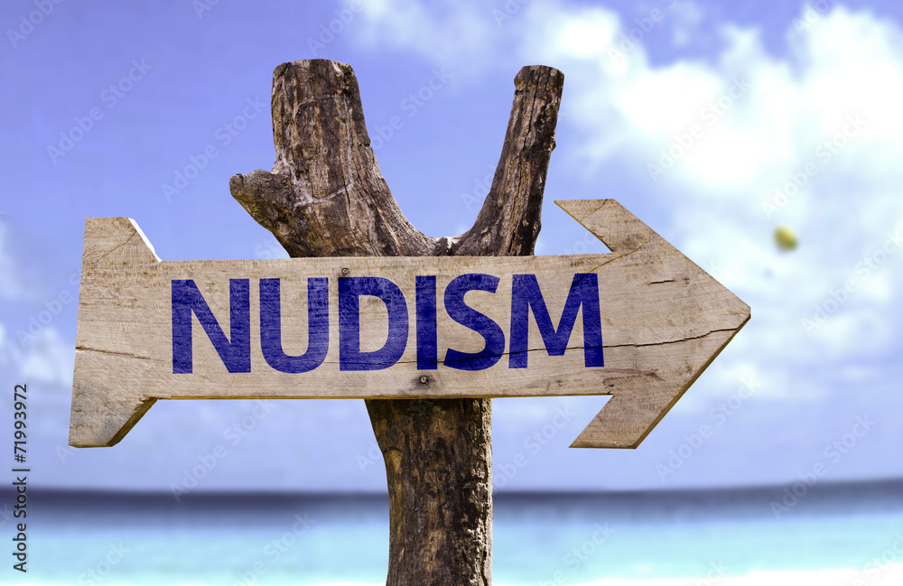 Nudism wooden sign with a beach on background