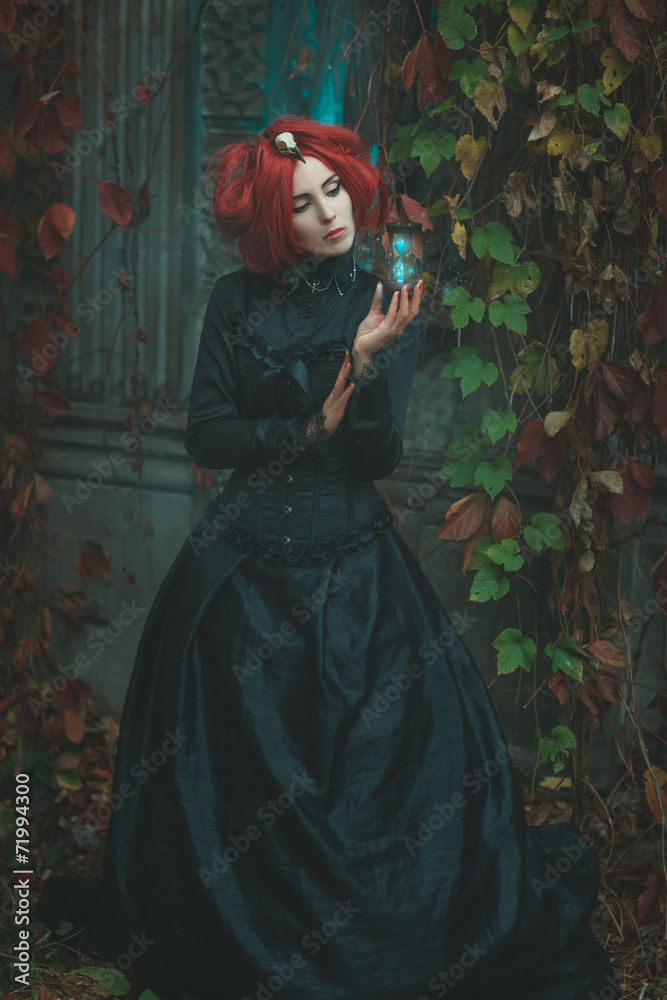 Fototapeta premium Fabulous girl holding an hourglass in his hand.