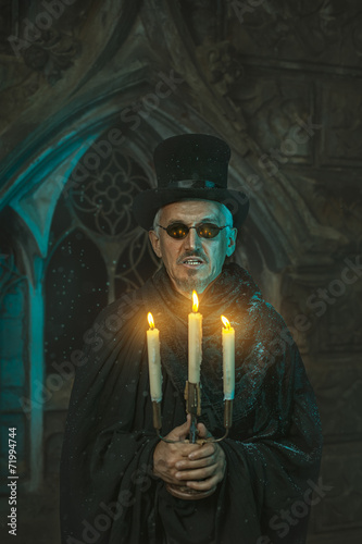 Warlock male with a candelabra in hand. photo