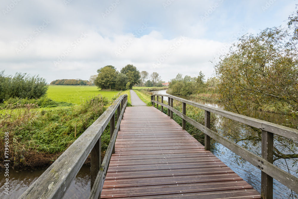 Wooden bridge in an autumnal landscape