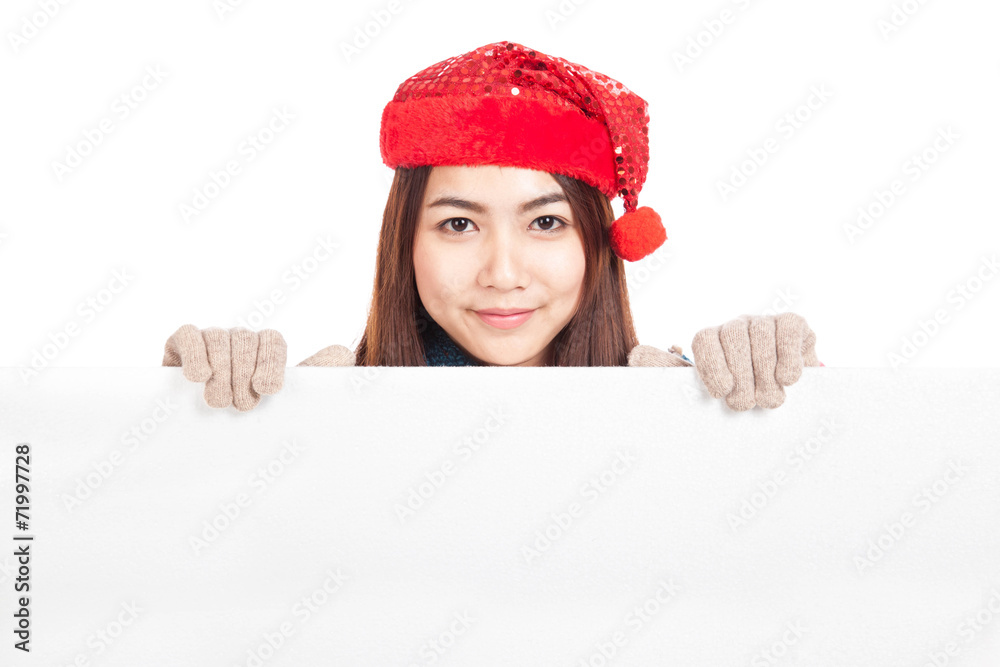 Asian girl with red christmas hat peeking from behind blank bann Asian girl with red christmas hat peeking from behind blank bann