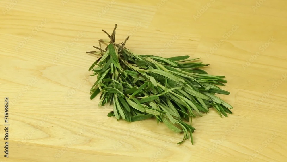 Beam rotates rosemary on a wooden board