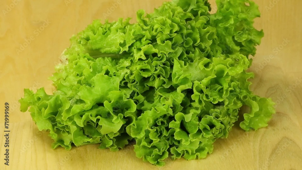 Lettuce turns on the background of wooden boards Lettuce turns on the background of wooden boards