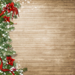 Christmas wood background  with poinsettia and firtree