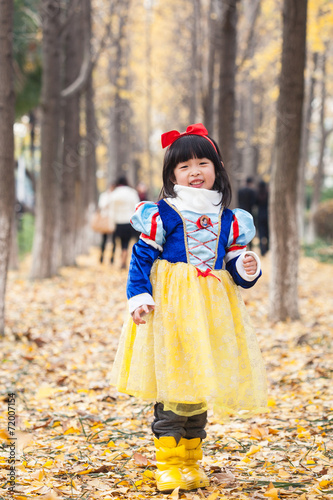 little girl dress in snow white costume in forest