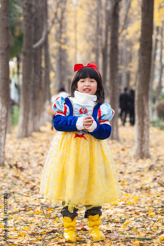 little girl dress in snow white costume in forest