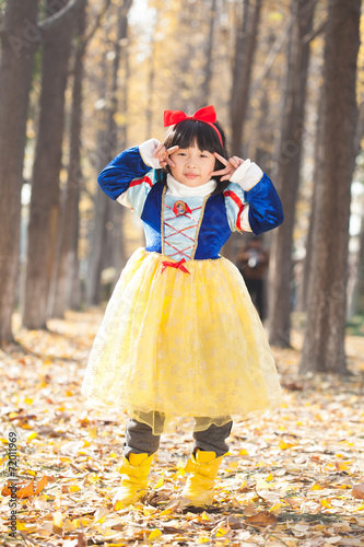 little girl dress in snow white costume in forest