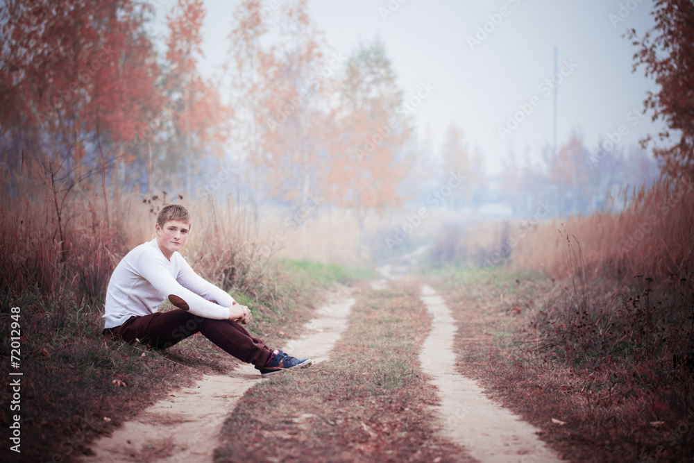 Fototapeta premium young men in autumn park