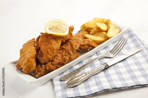 Viener chicken fries, breaded steak with french fries and lemon photo