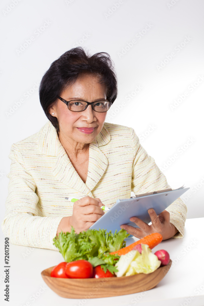 Nutritionist, Female Nutritionist act with a bowl of vegetable Nutritionist, Female Nutritionist act with a bowl of vegetable