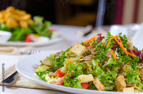 Plate of healthy leafy green salad with croutons
