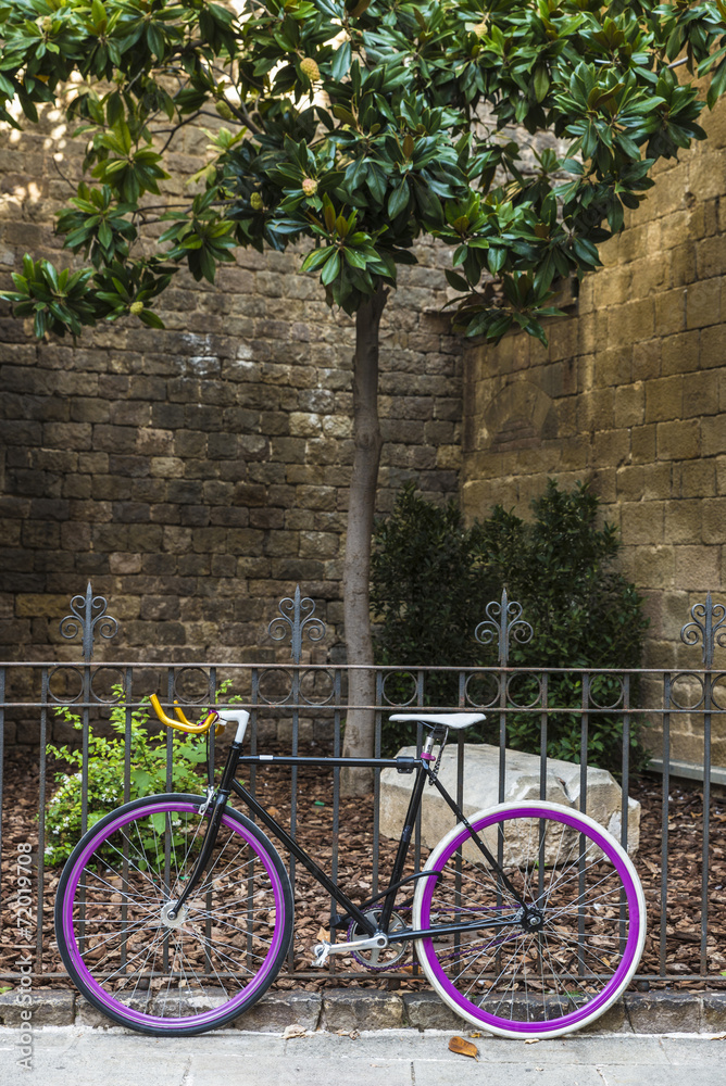 bicycle tied to a fence